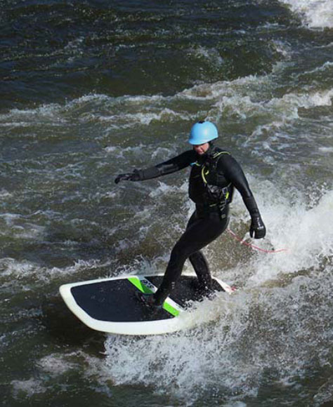 Hannah Ray J surfing on a lake.