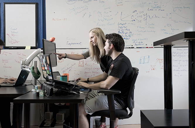 two people working together at a computer