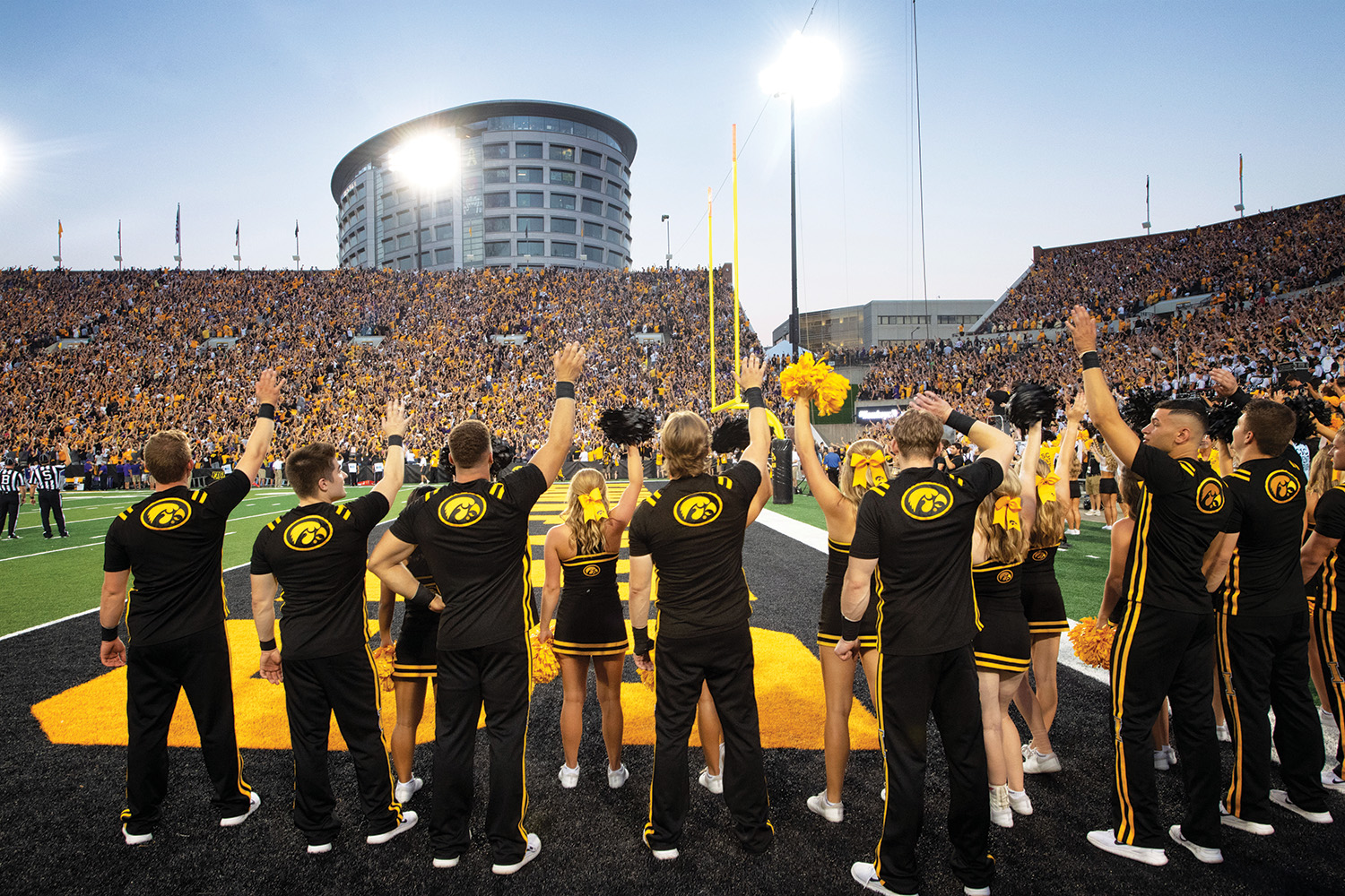 University of Iowa Cheerleaders wave to crowd at stadium