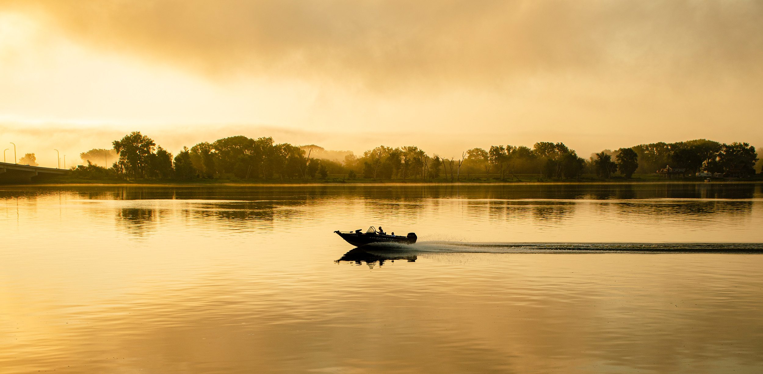 Boat on a lake at sunrise in Burlington, Iowa