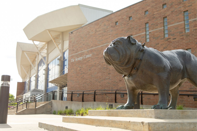Exterior view of the Knapp Center on Drake University campus with the large bulldog statue. 