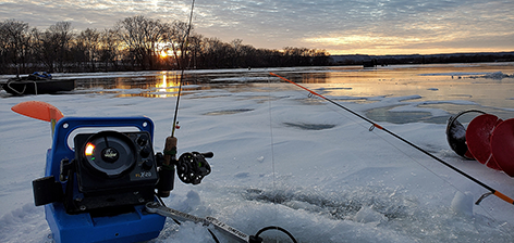 Fishing poles dropped through the ice.
