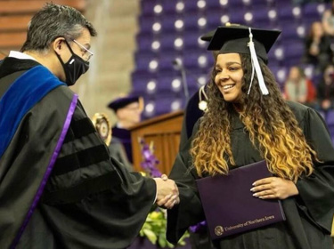 Graduating student receiving her diploma.
