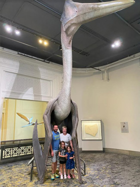 Wells family standing in a museum. 