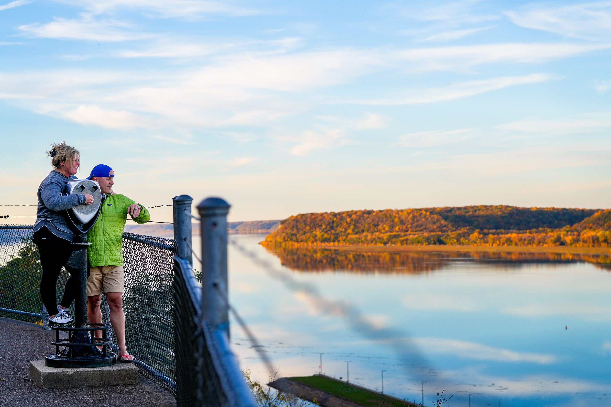 Two people viewing the scenic overlook of the Mississippi River in the fall in Dubuque, Iowa