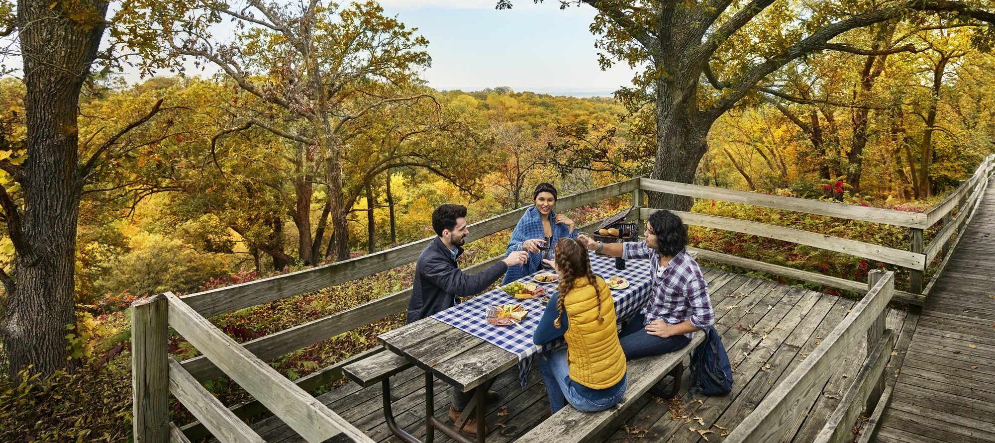 Group of friends having a picnic at a scenic outlook