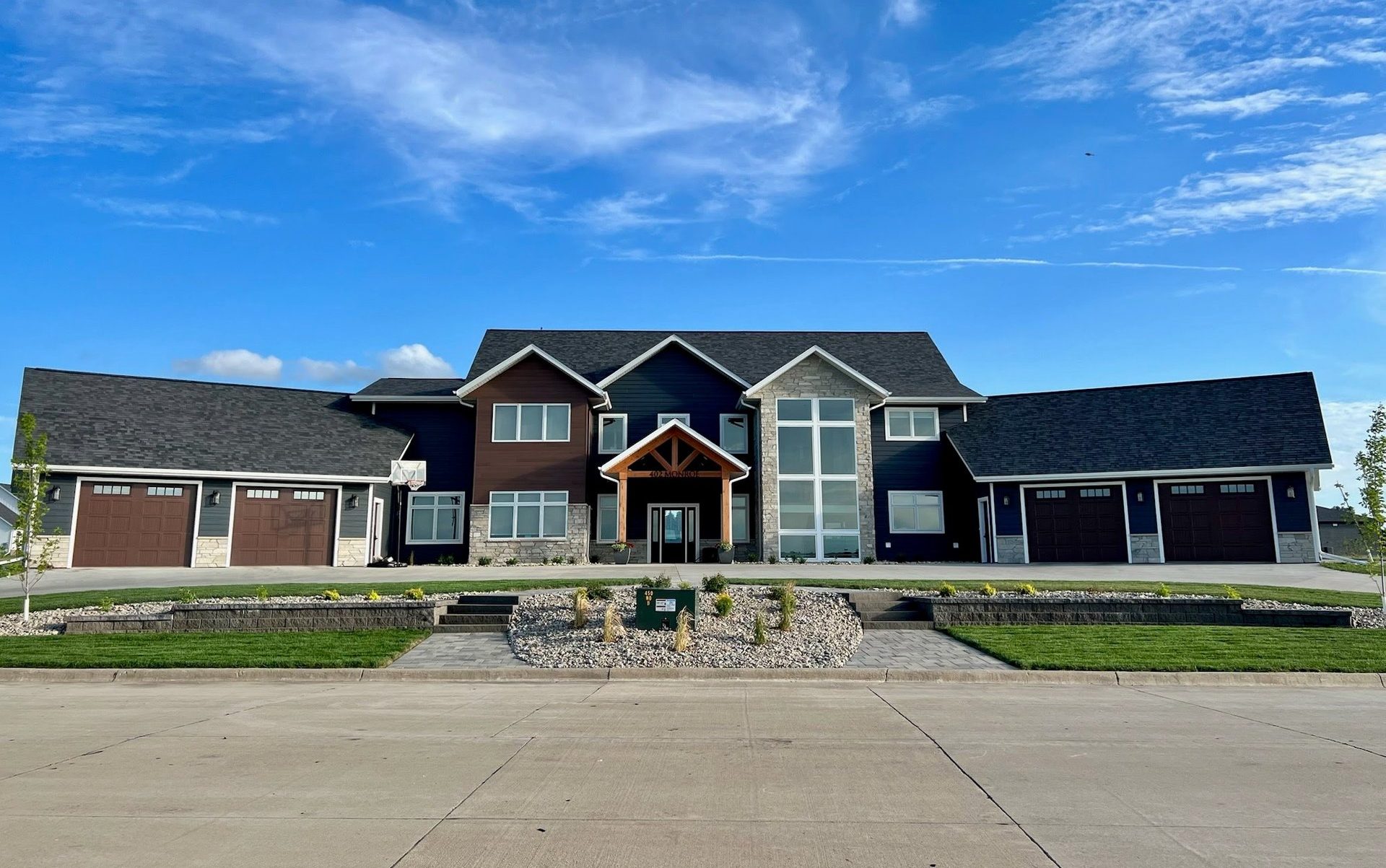 A two story home with four garage doors
