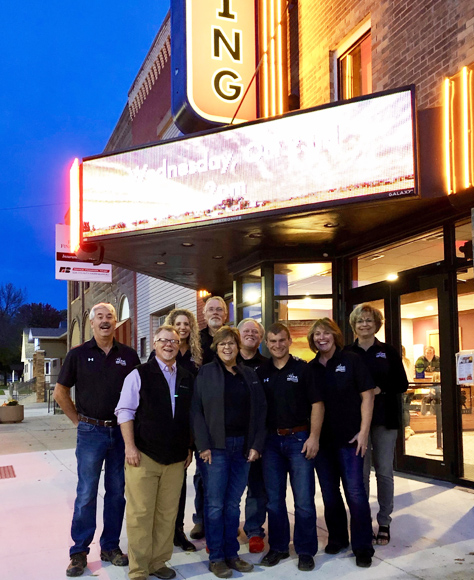 King Theatre in Ida Grove, Iowa with group of people standing outside.