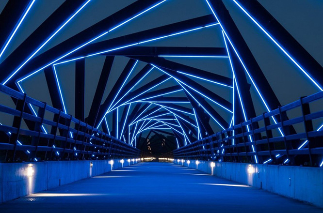 High Trestle Trail Bridge lit up at night.