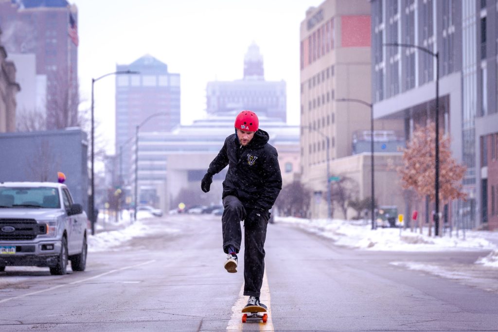 man skateboarding on city street