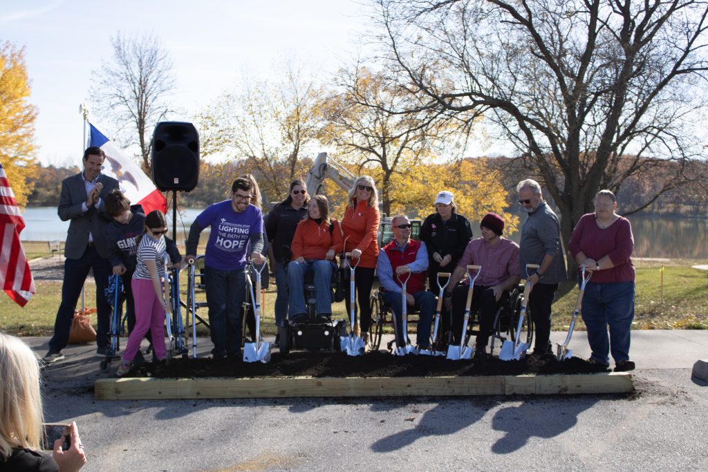 A group of people with disabilities attend a ribbon-cutting ceremony.