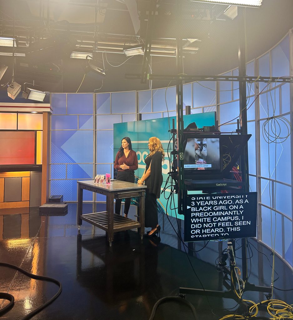 Two people on set during a news segment