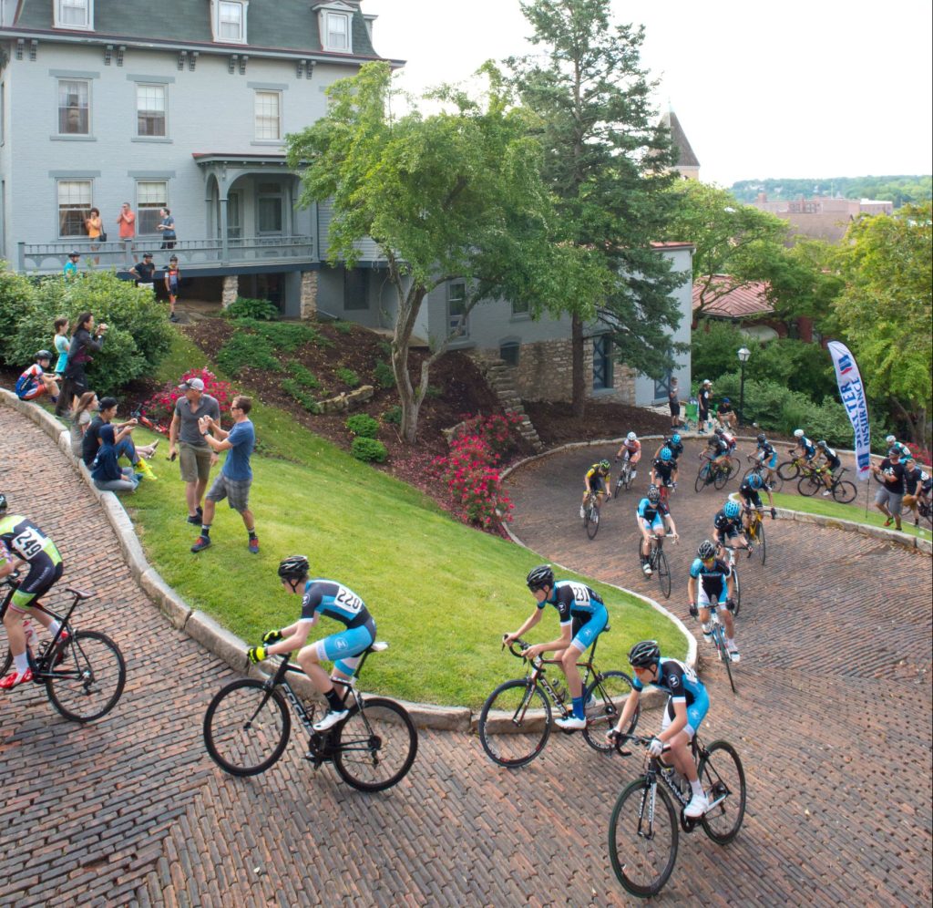 bicyclists riding up steep hill