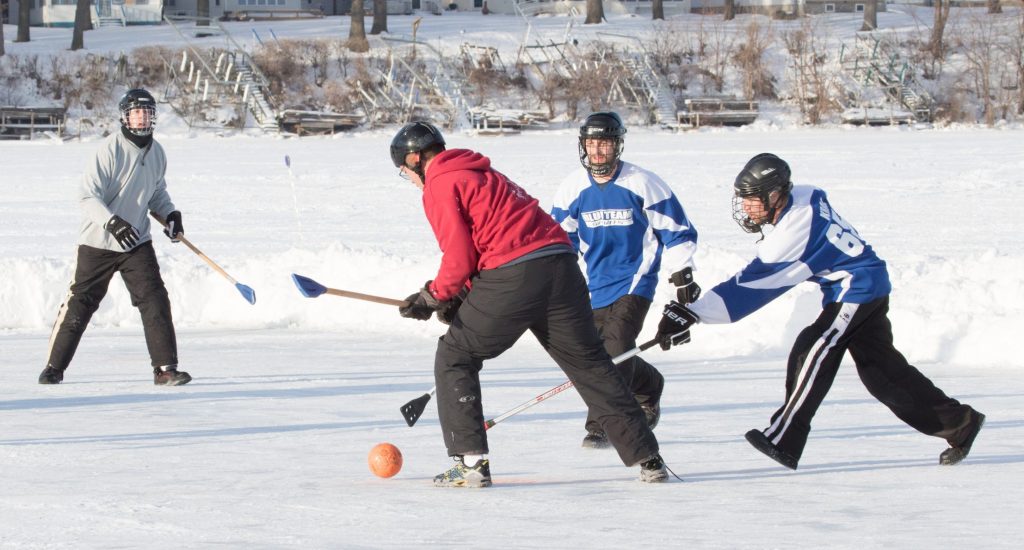 people playing game on ice during winter