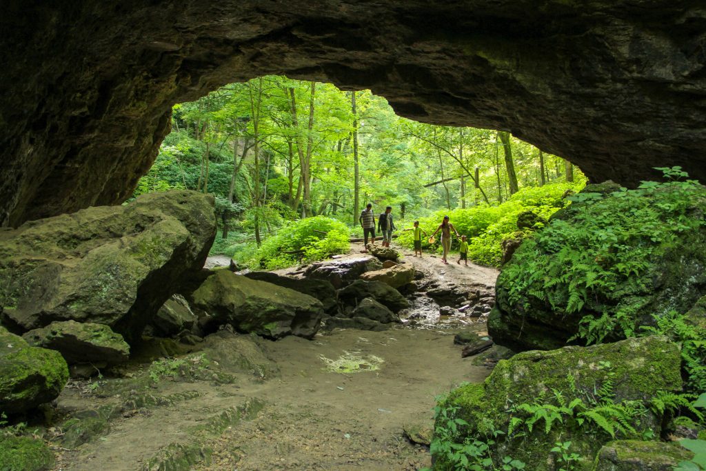 people walking into cave