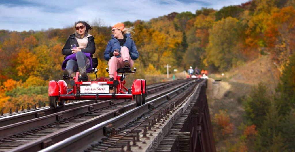 people riding on railroad track