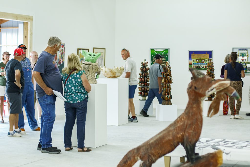 people wander through art gallery