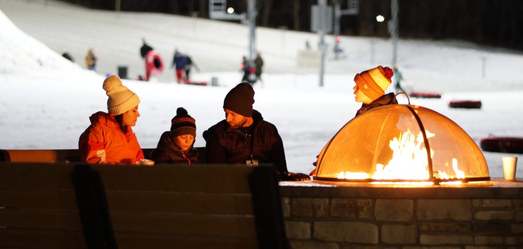 family next to fire during winter