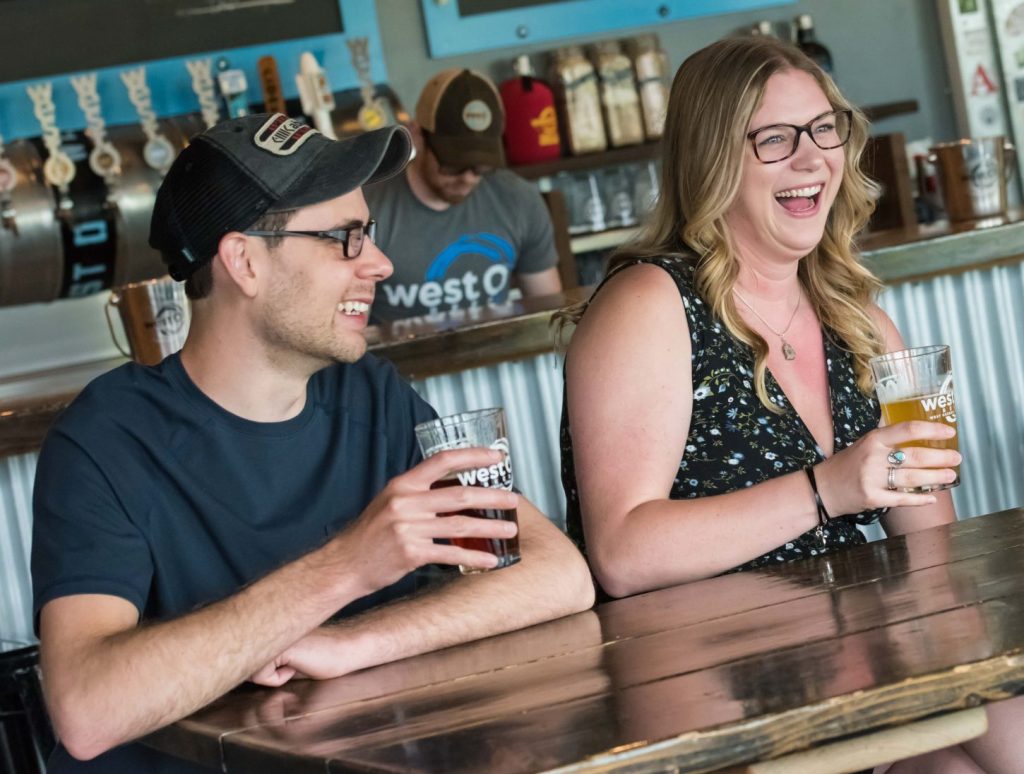 people sipping beers at a table