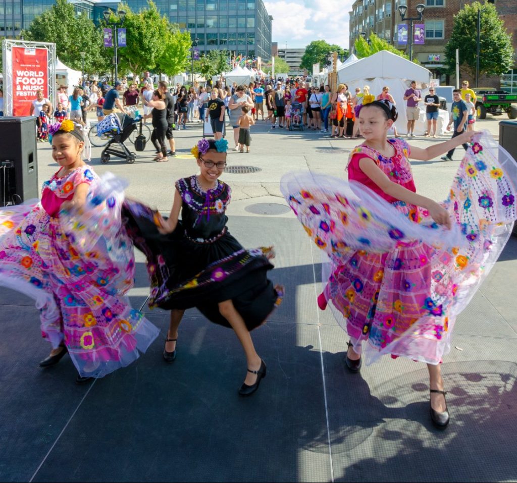 group of young dancers wearing cultural dresses