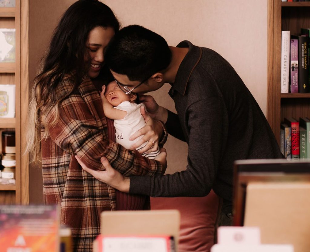 family holding baby in bookstore