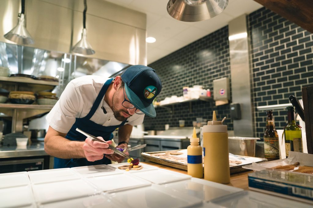 Chef preparing a dish in a kitchen