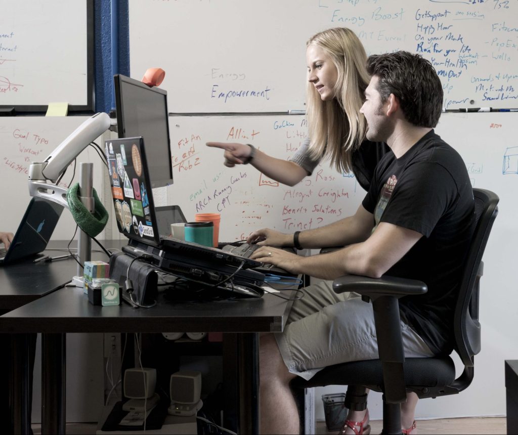 two people looking at computer screen