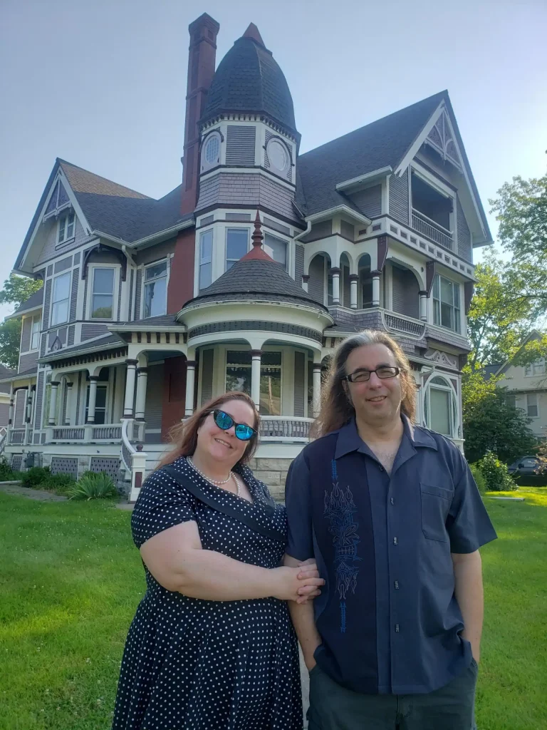 Homeowners Kendra and Richard Lint stand in front of historic James A. Beck House in Fairfield, Iowa